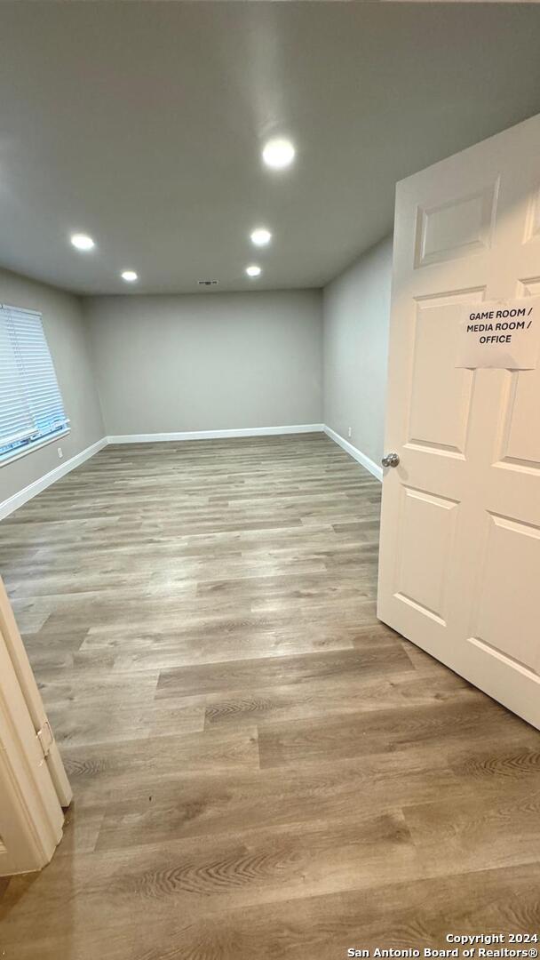 basement with hardwood / wood-style floors