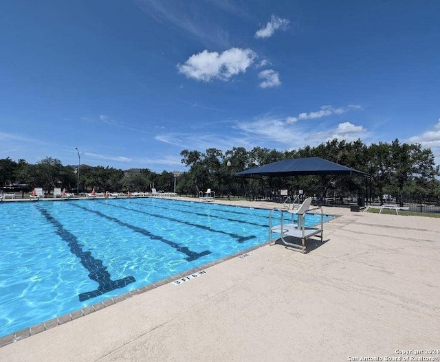 view of swimming pool with a patio area