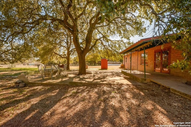 view of yard featuring french doors and a patio area