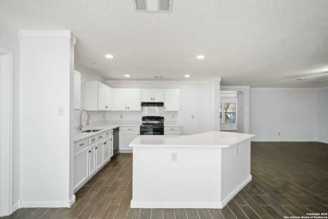 kitchen featuring sink, white cabinetry, a center island, electric range oven, and dishwasher