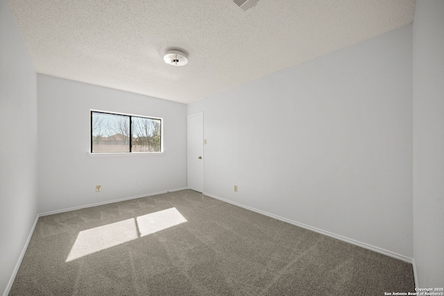 carpeted spare room with a textured ceiling