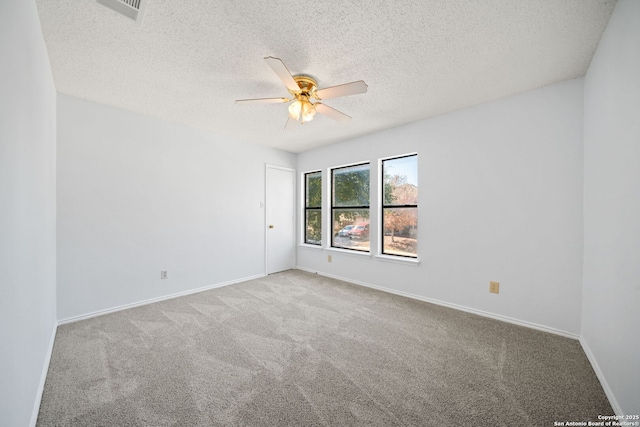 carpeted spare room featuring a textured ceiling and ceiling fan