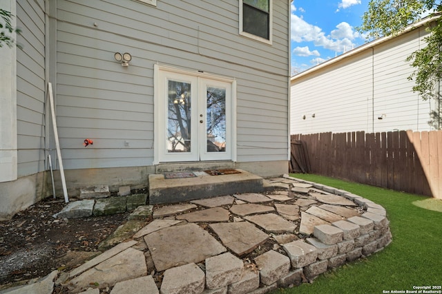 view of exterior entry with a patio and french doors