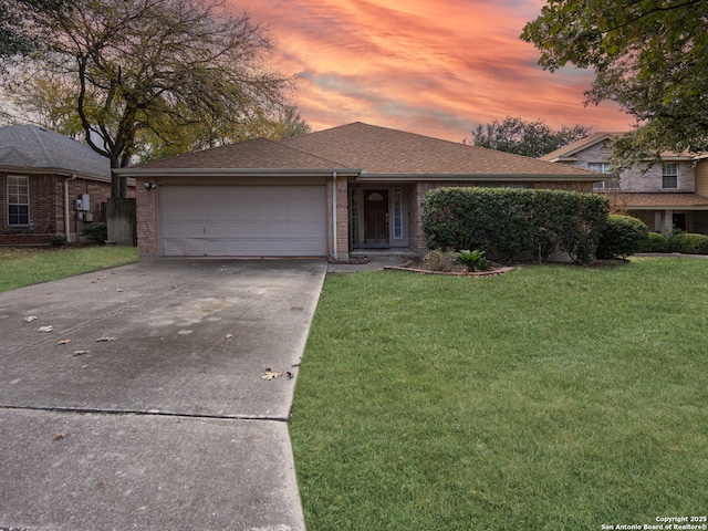 view of front of house featuring a garage and a lawn