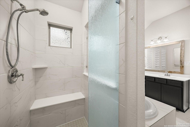 bathroom featuring a garden tub, a tile shower, and vanity