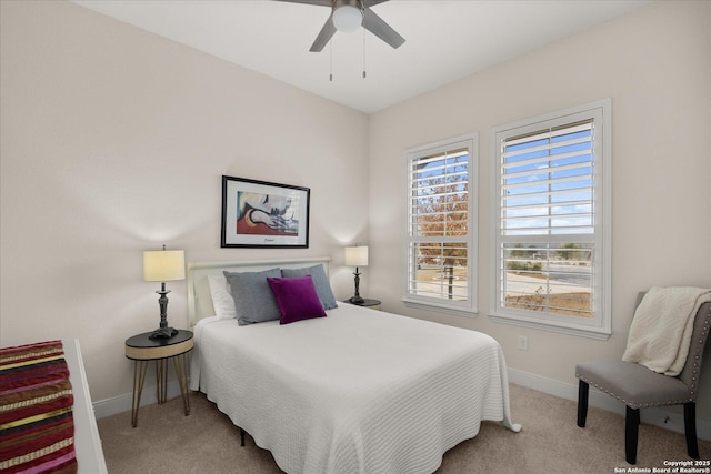 carpeted bedroom featuring ceiling fan and baseboards