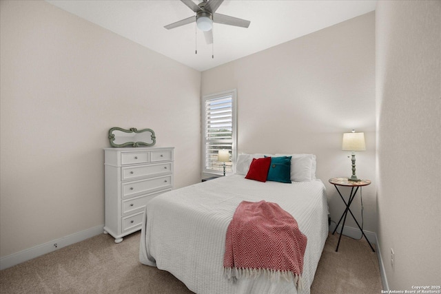 bedroom featuring light colored carpet, ceiling fan, and baseboards