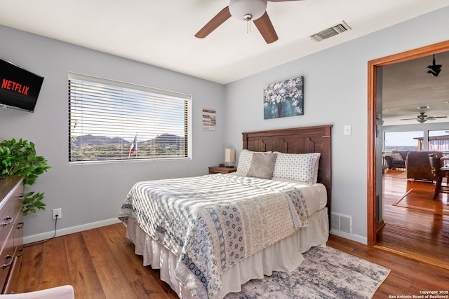 bedroom with ceiling fan and hardwood / wood-style floors