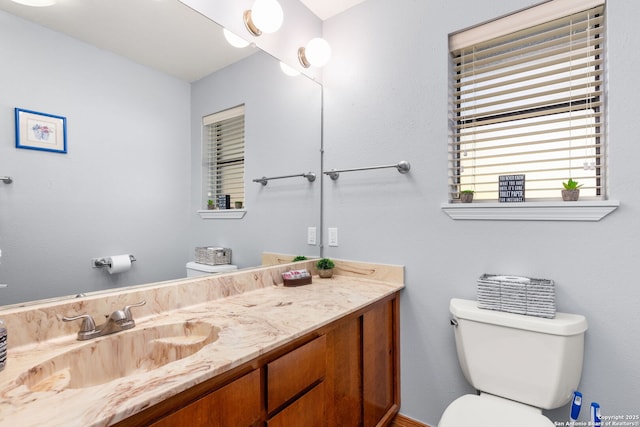 bathroom featuring vanity and toilet