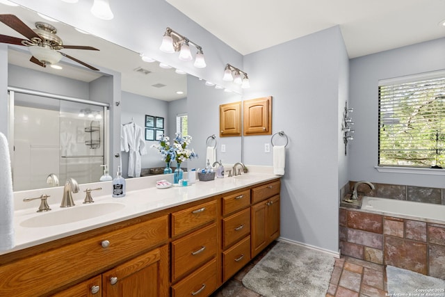 bathroom with vanity, ceiling fan, shower with separate bathtub, and a healthy amount of sunlight