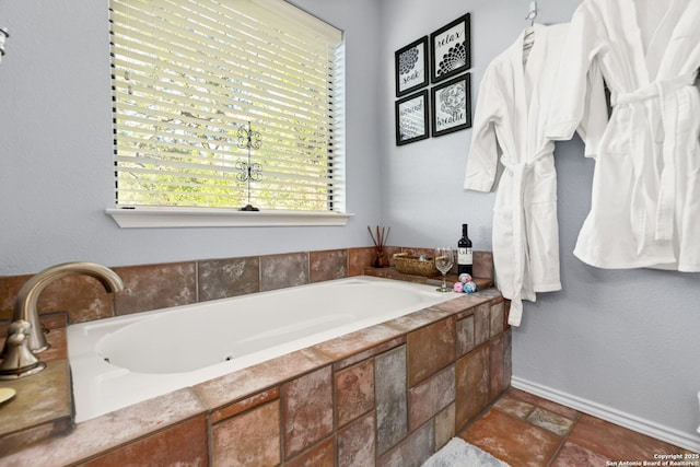 bathroom with a relaxing tiled tub