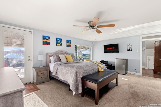 carpeted bedroom with stainless steel fridge, ceiling fan, and access to outside