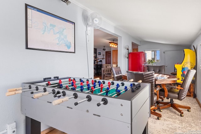 recreation room featuring carpet floors and vaulted ceiling