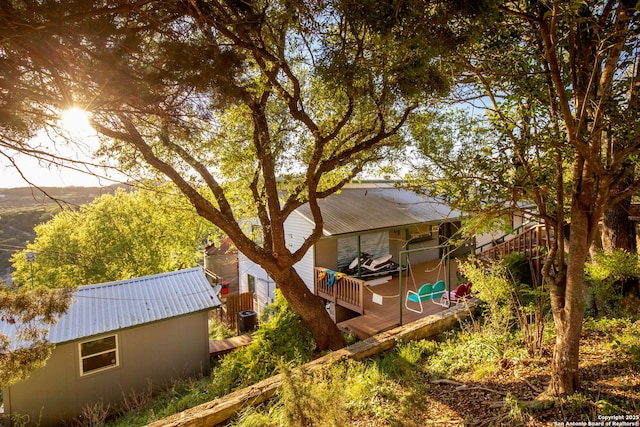 exterior space featuring a wooden deck and central air condition unit