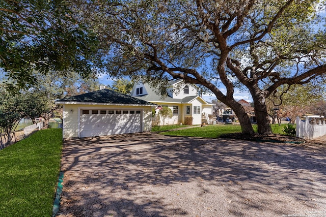 view of front of property with a garage and a front lawn