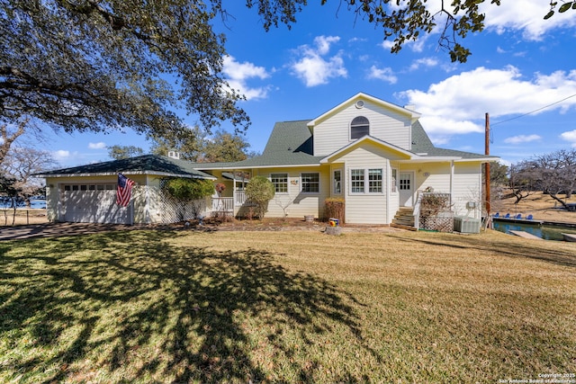 view of front of home with a garage, a porch, and a front lawn