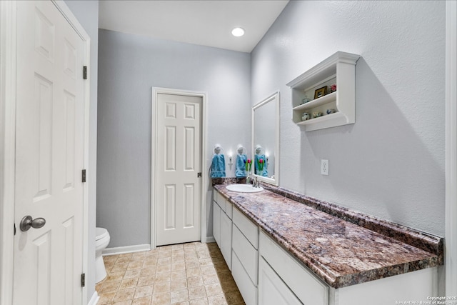 bathroom featuring vanity and toilet