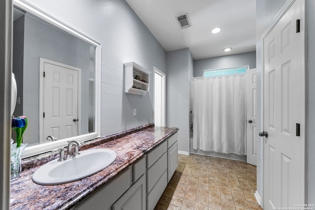 bathroom featuring vanity and shower / bath combo with shower curtain