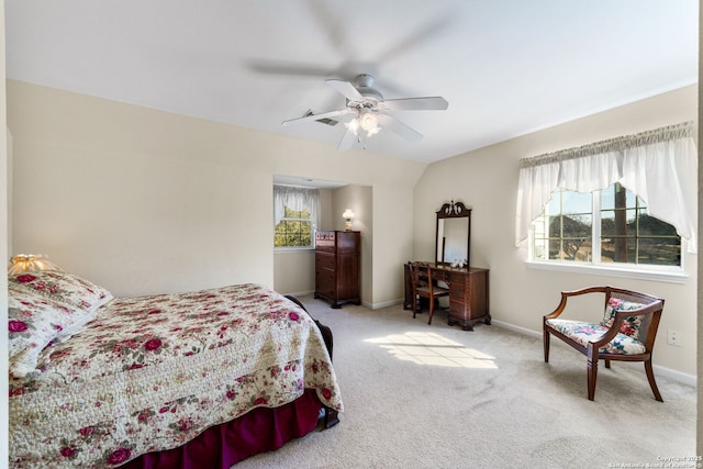 carpeted bedroom featuring multiple windows and ceiling fan