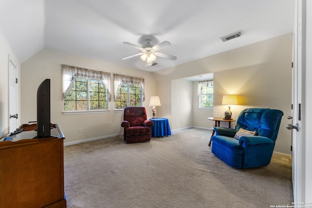 living area featuring lofted ceiling, light carpet, and ceiling fan