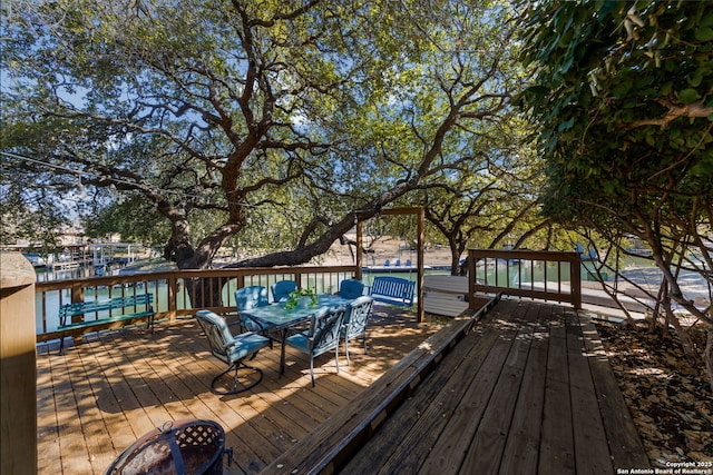 wooden terrace with an outdoor fire pit