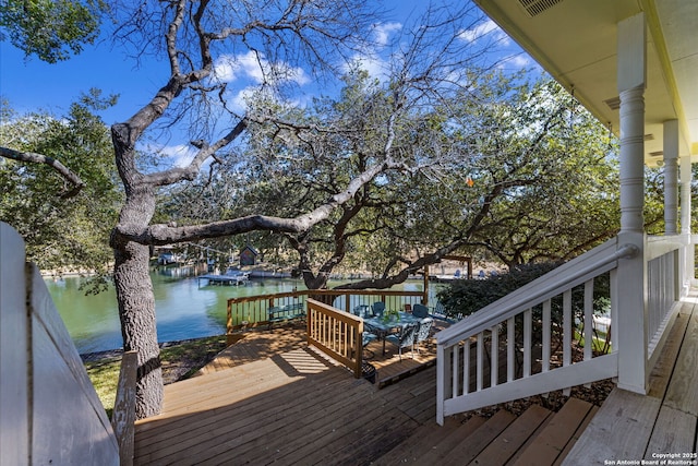 wooden deck featuring a water view