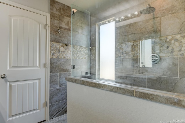 bathroom with tiled shower