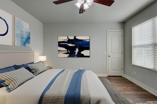 bedroom featuring ceiling fan and dark hardwood / wood-style flooring