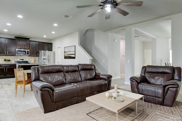 living room with ceiling fan and light tile patterned flooring