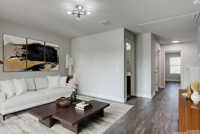 living room with wood-type flooring and a notable chandelier