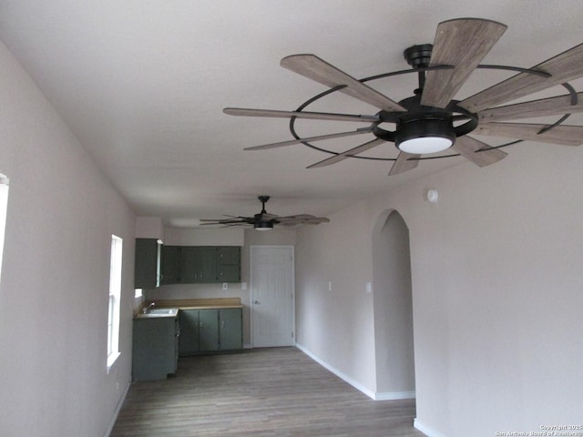 kitchen featuring sink, wood-type flooring, and ceiling fan