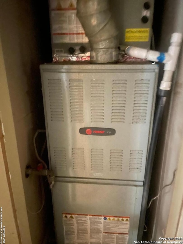 utility room featuring heating unit