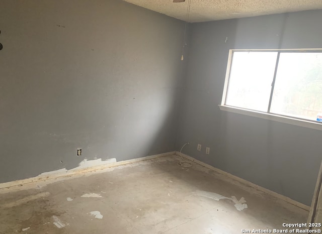 unfurnished room featuring a textured ceiling