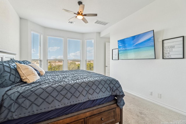 carpeted bedroom featuring ceiling fan, visible vents, and baseboards