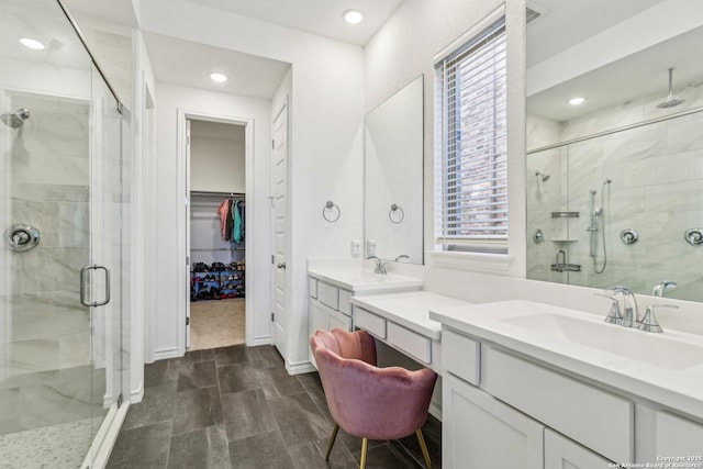 bathroom featuring a stall shower, a walk in closet, vanity, and recessed lighting