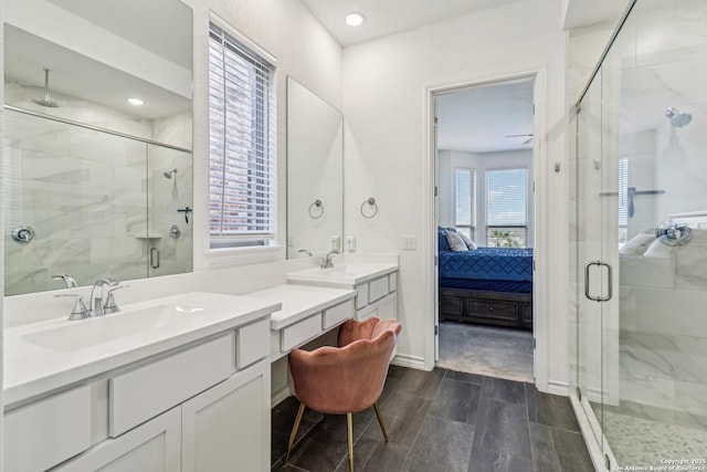 bathroom with a stall shower, connected bathroom, vanity, and recessed lighting