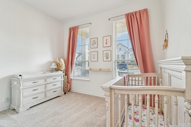 bedroom featuring a nursery area, carpet flooring, baseboards, and multiple windows