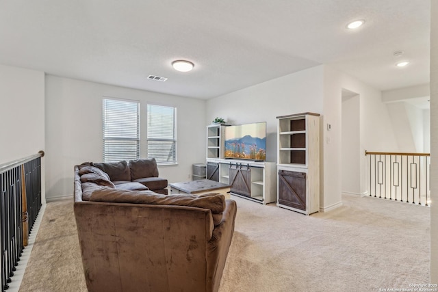 living room with recessed lighting, visible vents, light carpet, and baseboards