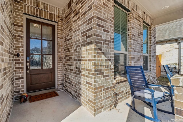 view of exterior entry with brick siding