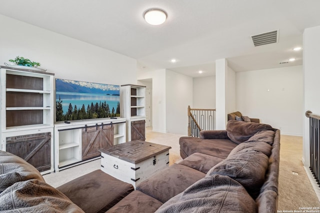 living area featuring light carpet, visible vents, and recessed lighting