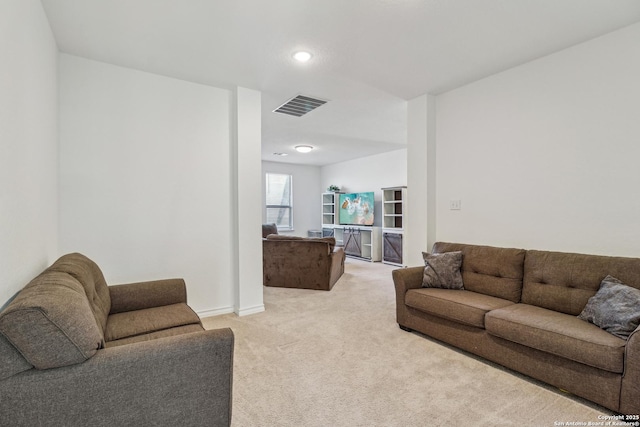 living area featuring light carpet, visible vents, and baseboards