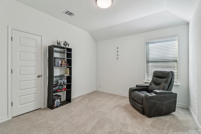 living area featuring vaulted ceiling, carpet floors, visible vents, and baseboards