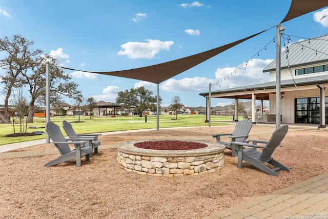 view of yard with an outdoor fire pit and a patio