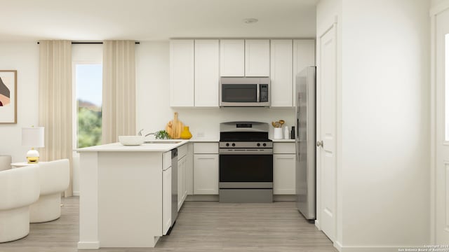 kitchen with appliances with stainless steel finishes, kitchen peninsula, light hardwood / wood-style flooring, and white cabinets