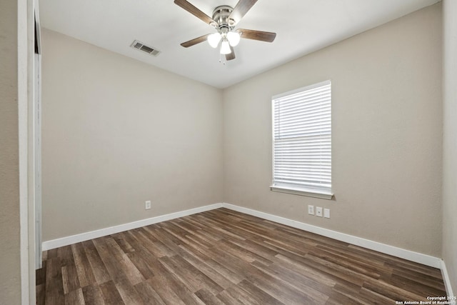 unfurnished room featuring dark wood-type flooring and ceiling fan