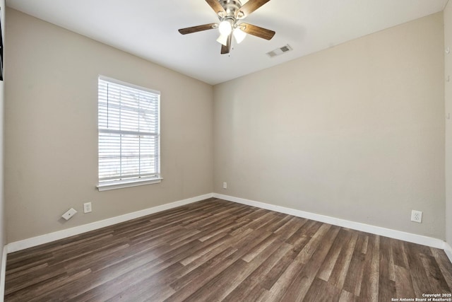 spare room with dark hardwood / wood-style flooring and ceiling fan