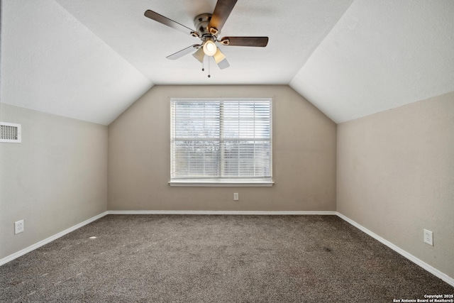 additional living space featuring ceiling fan, vaulted ceiling, carpet, and a textured ceiling