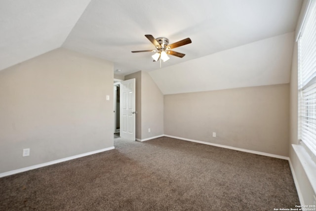 bonus room with ceiling fan, vaulted ceiling, and dark colored carpet