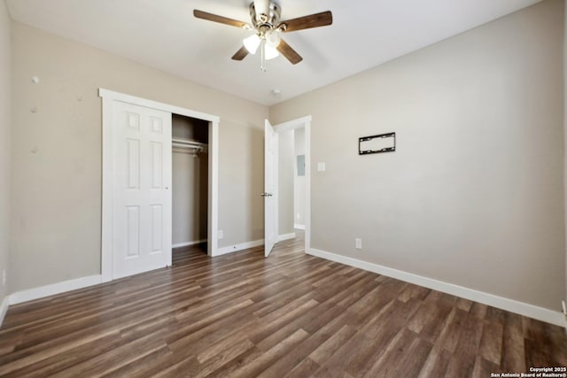 unfurnished bedroom featuring dark wood-type flooring, ceiling fan, and a closet