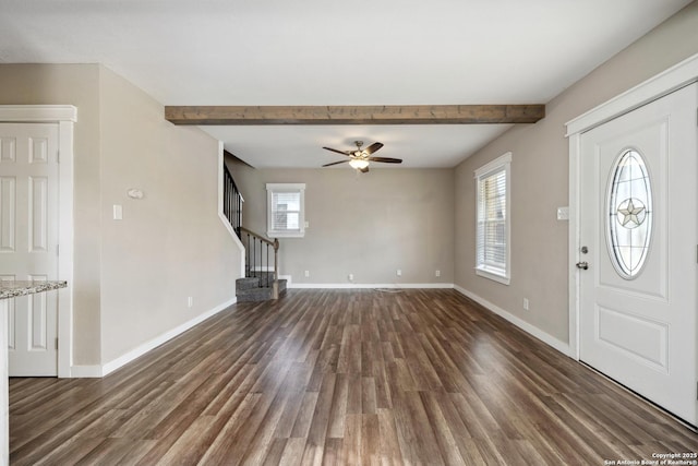 foyer with ceiling fan, dark wood-type flooring, and beamed ceiling